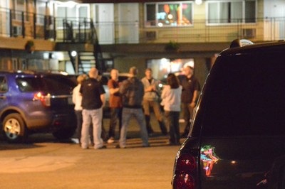 FBI special agents and local police officers hold a briefing in motel parking lot during an Operation Cross Country undercover operation in 2014.