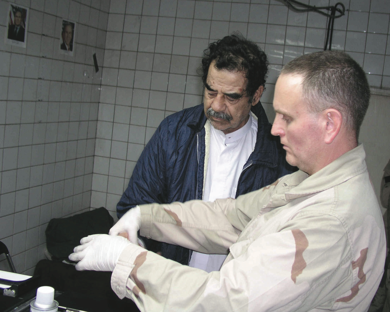 FBI Agent Fingerprints Saddam Hussein After Capture