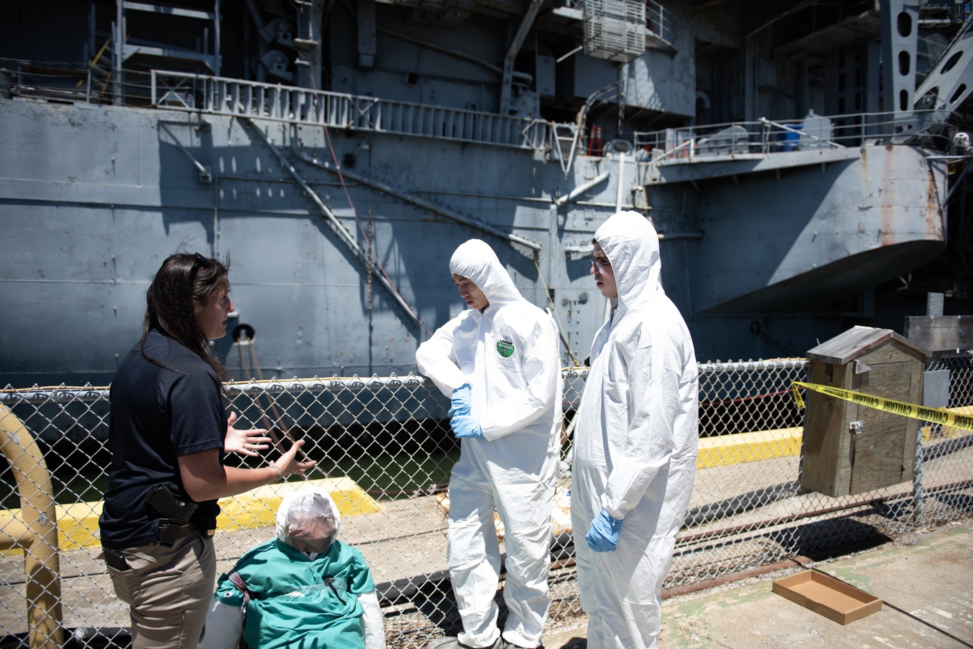 FBI San Francisco Teen Academy students try on Tyvek suits in front of the USS Hornet in Alameda, California.