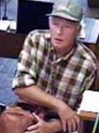 Bank robber nicknamed the Satchel Bandit who robbed two banks in California on separate days in August 2013. The suspect here is robbing the Union Bank located at 437 Old Mammoth Road in Mammoth Lakes, California on August 2, 2013.