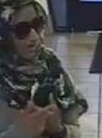 The Bombshell Bandit is believed to be responsible for robbing three bank banks, in three different cities, from June 6, 2014 to July 14, 2014. Here, she is shown robbing the Wells Fargo Bank, 1601 North Mc Culloch, Lake Havasu, Arizona, on Tuesday, July 8, 2014.