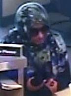 The Bombshell Bandit is believed to be responsible for robbing three bank banks, in three different cities, from June 6, 2014 to July 14, 2014. Here, she is shown robbing the Comerica Bank, 3361 Rosecrans Street, Suite 9A, San Diego, California, on Monday, July 14, 2014.