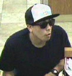 The Risky Business Bandit is believed to be responsible for robbing four banks from April 18, 2014 to Friday, July 25, 2014. Here, he is shown robbing the Wells Fargo Bank, 10535 Craftsman Way, San Diego, California, on Tuesday, May 13, 2014.