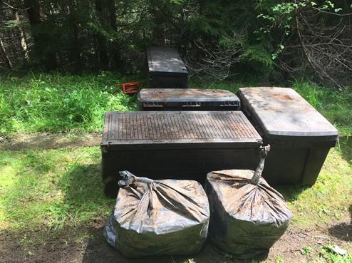 Cache of criminal accessories and stolen goods hidden by bank robber Bradley Steven Robinett in the Olympic National Forest and located by investigators on May 22, 2015.