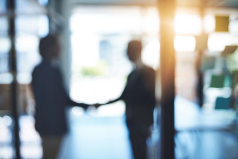 Blurred Image of Two People Shaking Hands (Stock Photo) Blurred Image of Two People Shaking Hands (Stock Photo)