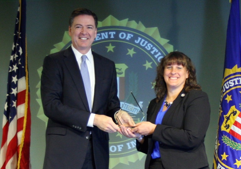Suzanne Phegley Receives Director’s Community Leadership Award from Director Comey on April 15, 2016