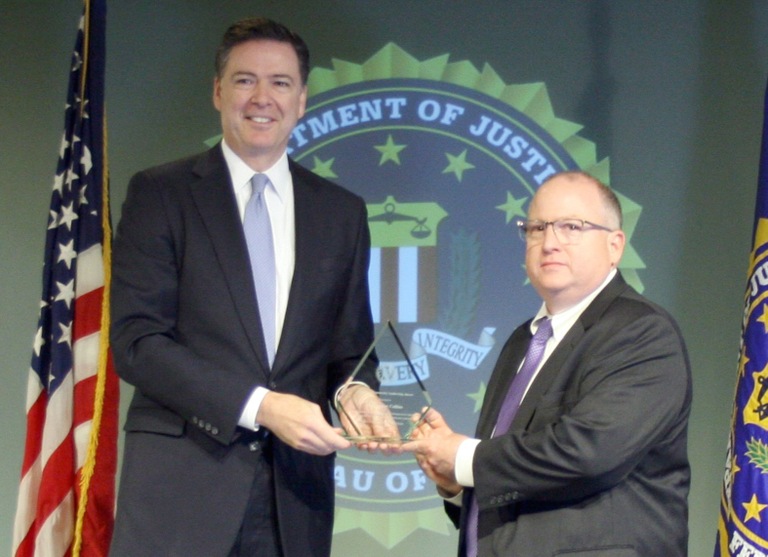 Dr. Thomas Collins Receives Director’s Community Leadership Award from Director Comey on April 15, 2016