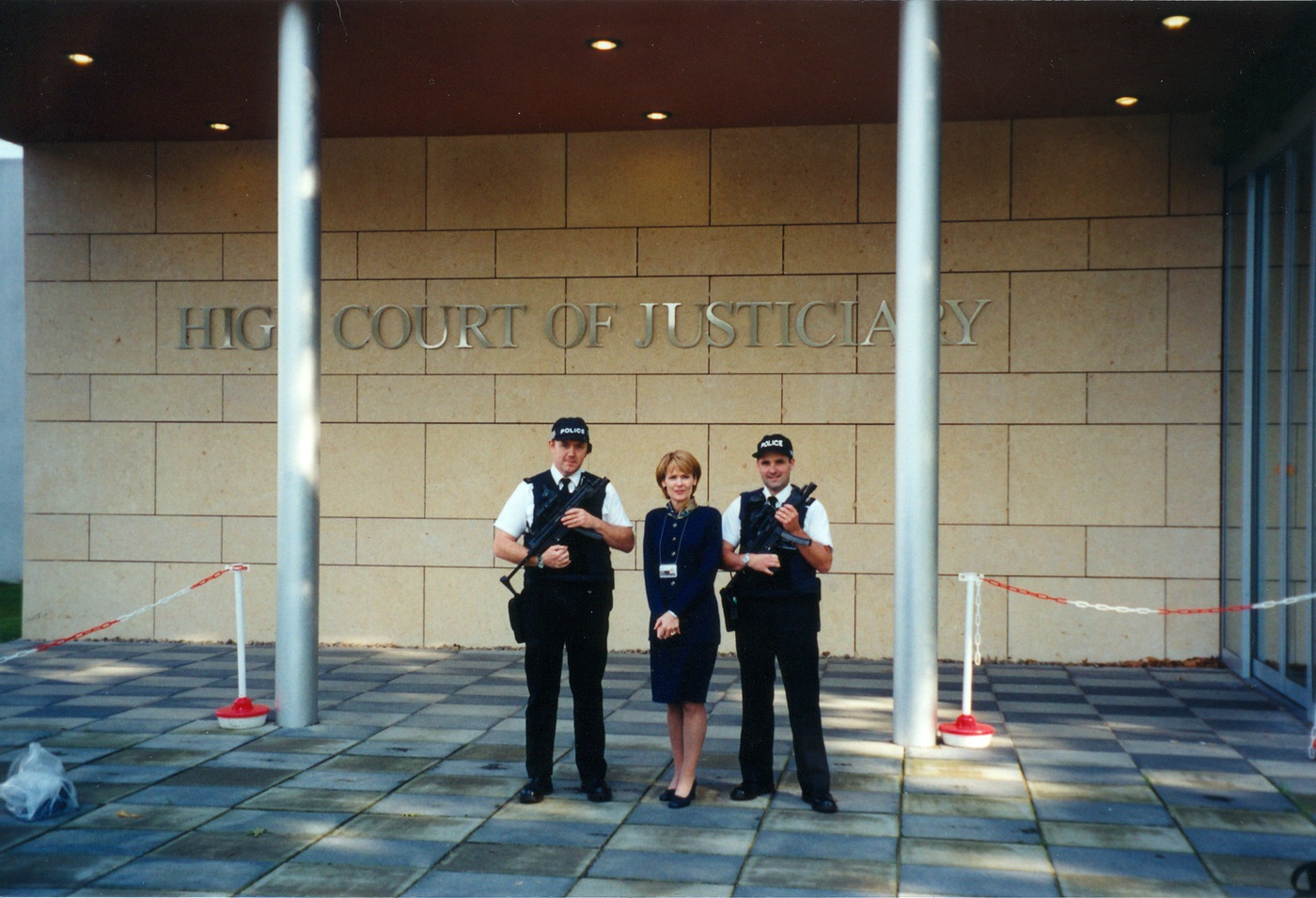 Kathryn Turman stands alongside guards at the High Court of Justiciary at Camp Zeist in Utrecht, the Netherlands, in 2000.