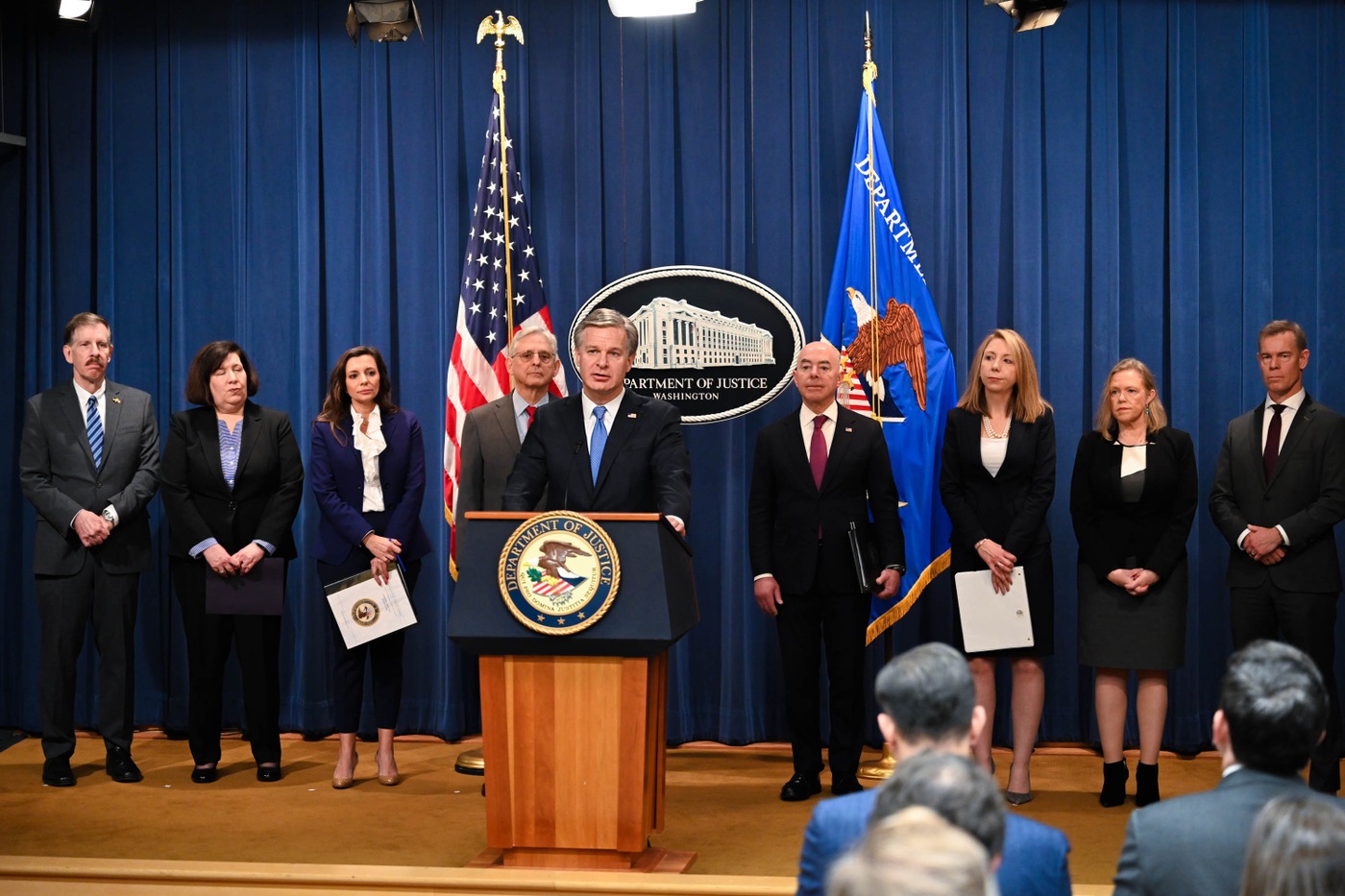 FBI Director Christopher Wray (at podium) speaks at a December 6, 2023, press conference alongside other federal officials including Attorney General Merrick B. Garland (at Wray's immediate left) and Secretary of Homeland Security Alejandro Mayorkas. The press conference was held in Washington, D.C.