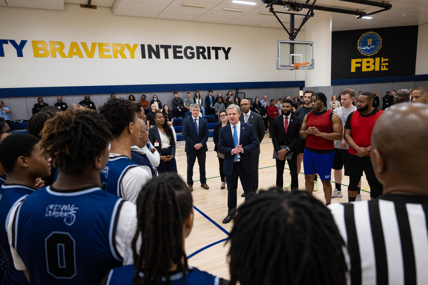 Director Christopher Wray addresses teams before their match during a WFO community outreach event at FBI Headquarters on January 24, 2024.