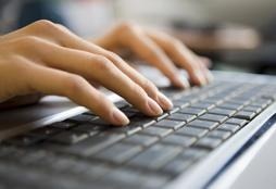 Woman Typing on Computer