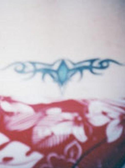 Tribal tattoo on her lower back